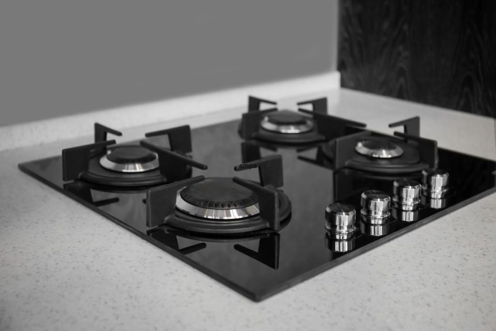 A black and white image of a classic gas stove, showcasing its vintage design and intricate details.
