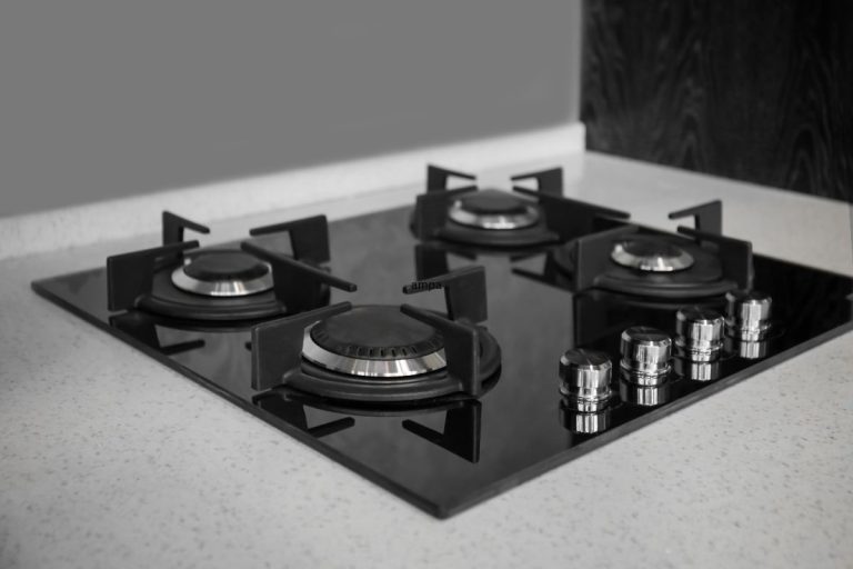 A black and white image of a classic gas stove, showcasing its vintage design and intricate details.