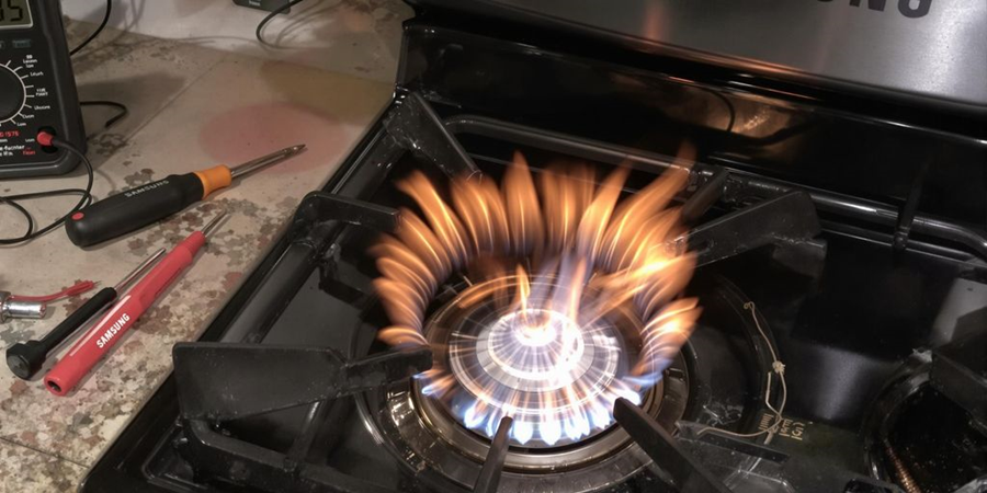 A gas stove ignited with vibrant flames, showcasing the cooking element in action.
